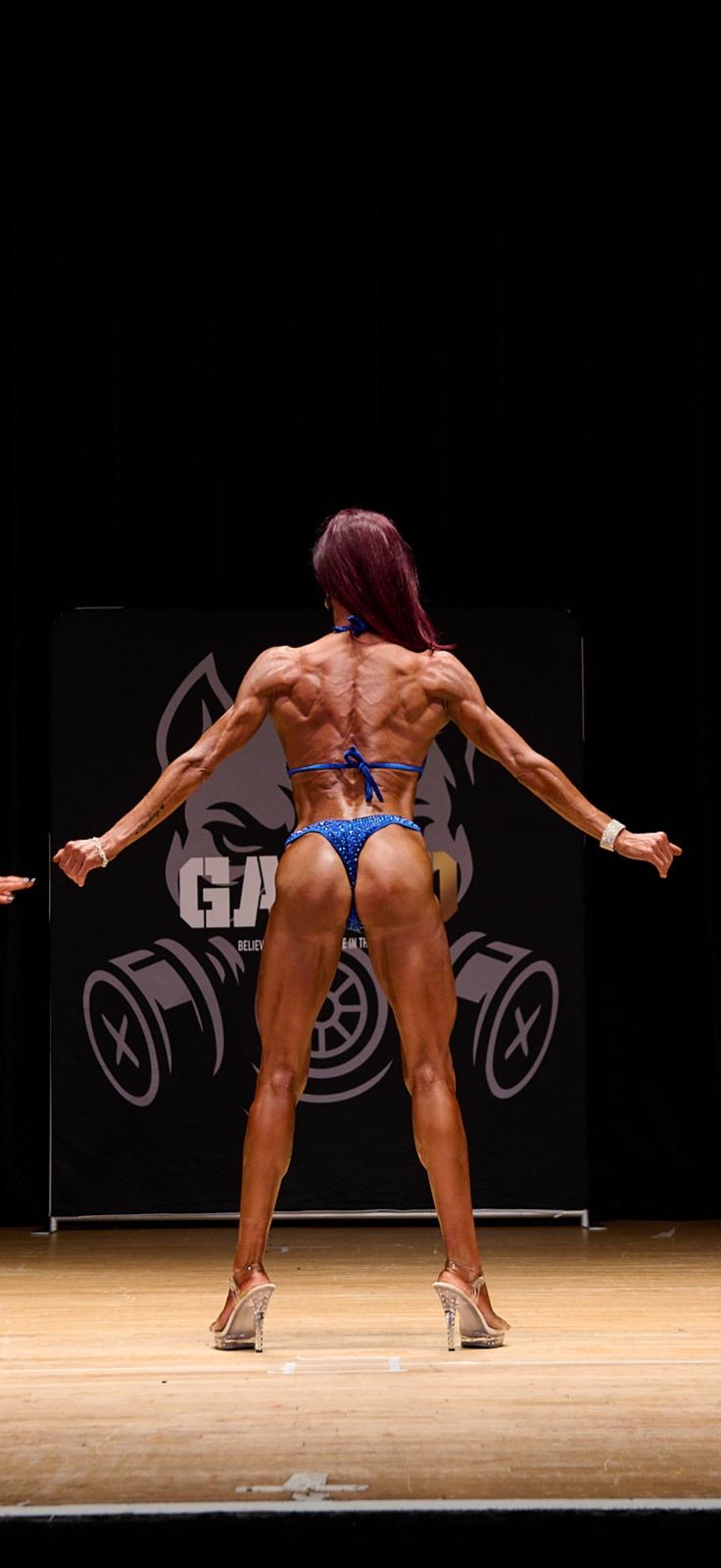 Gas Mark 10 back pose wide stance — blue suit